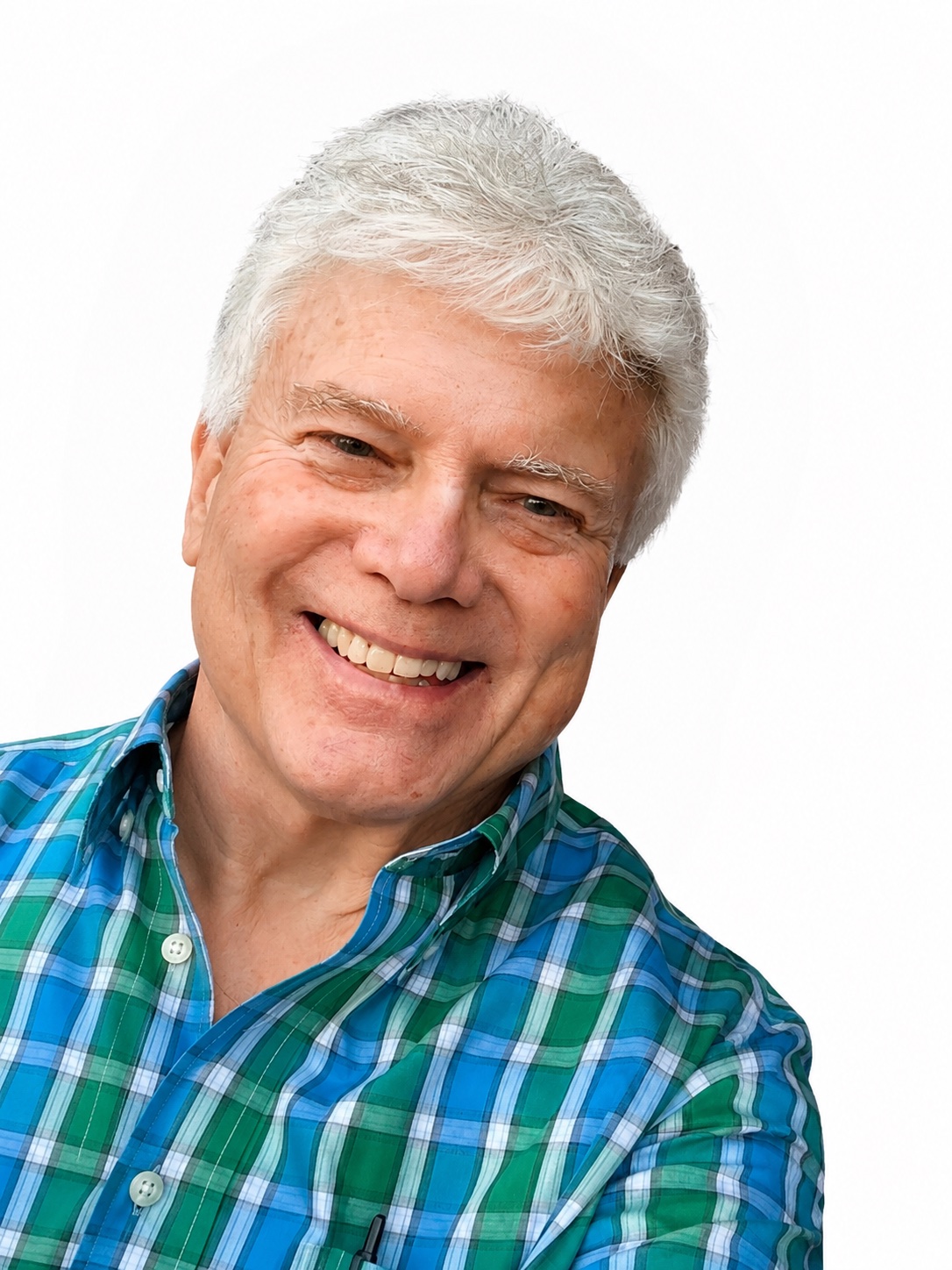 Dr. Ned Hallowell smiling, wearing a blue plaid shirt